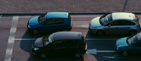 Illustrative reference image: stationary vehicles in an urban road environment