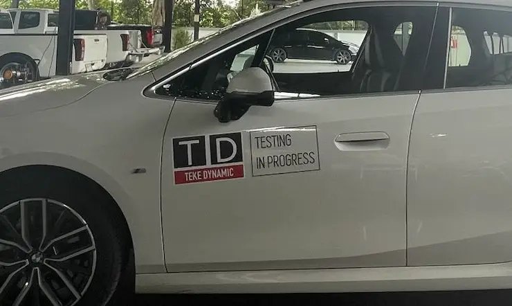 Vehicle displaying a Testing in Progress sign